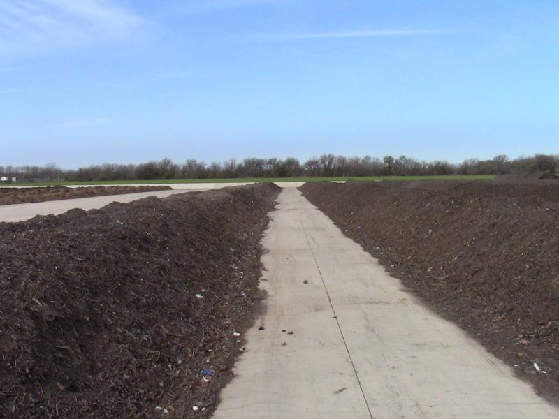 Rows of sewage sludge mixed with yard trimmings at a "biosolids" facility in Austin, Texas.