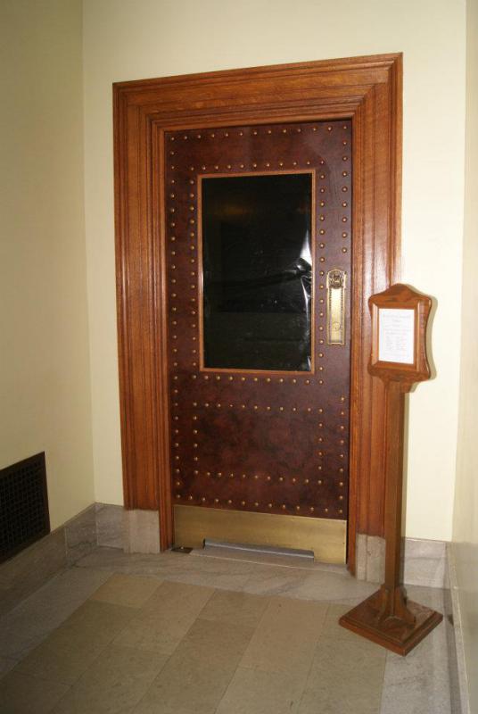 picture of the door to the Assembly gallery with black plastic over the window